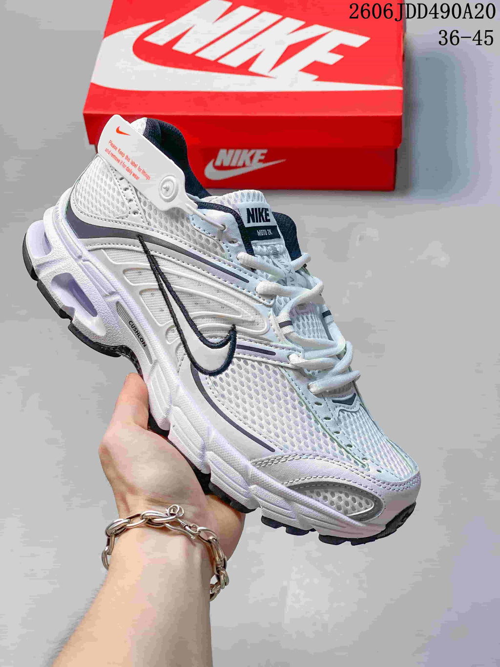White mesh Nike Air Max Moto 2K sneaker with dark Swoosh detail