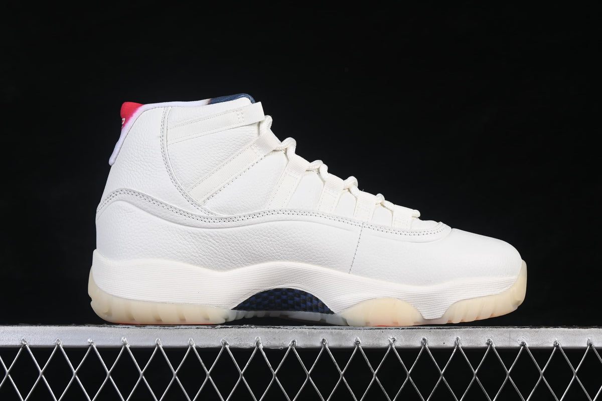 Side view of a white Air Jordan 11 Retro high-top with multicolor collar accents and a translucent-looking outsole.