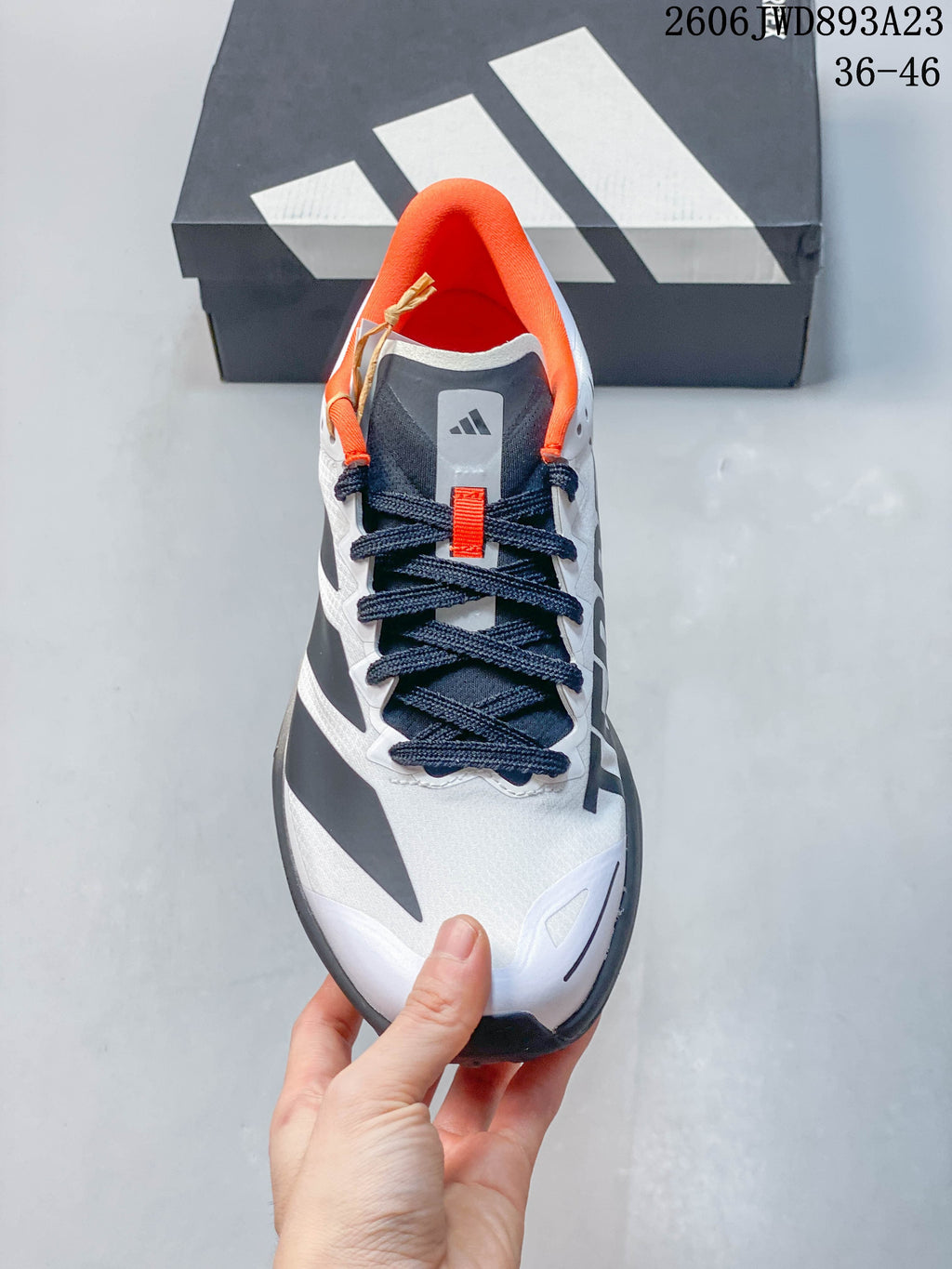 Top view showing the laces, tongue, and orange collar lining.