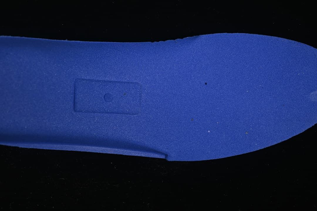 Blue-colored insert or footbed component shown separately against a dark background