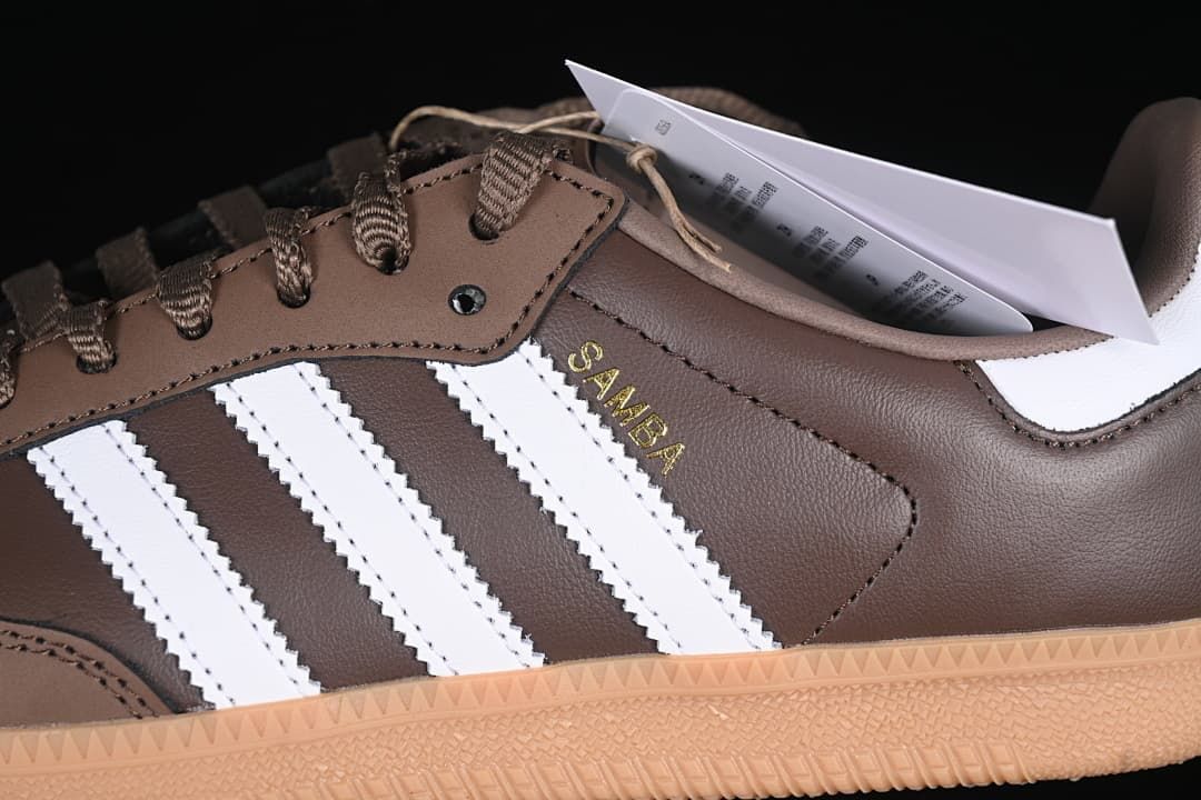 Close-up of white side stripes, brown upper and gold Samba lettering