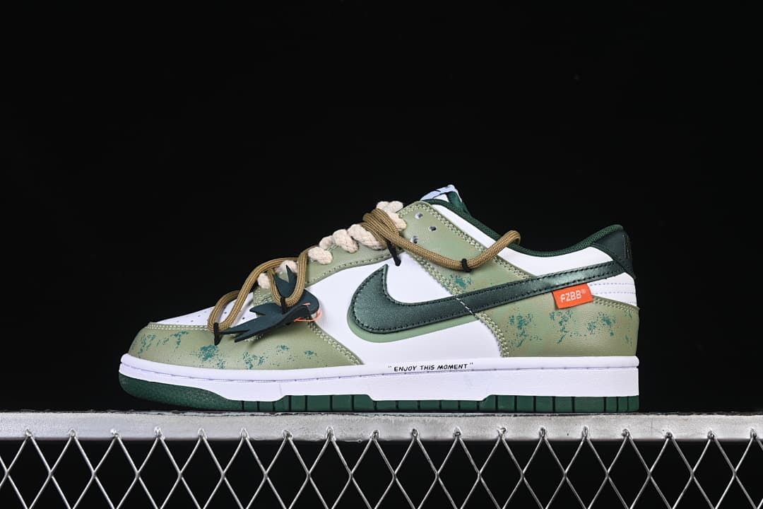 Side view of a white and green low-top Nike Dunk with layered laces