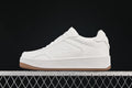 Side view of a white Alo Yoga low-top sneaker with a gum outsole