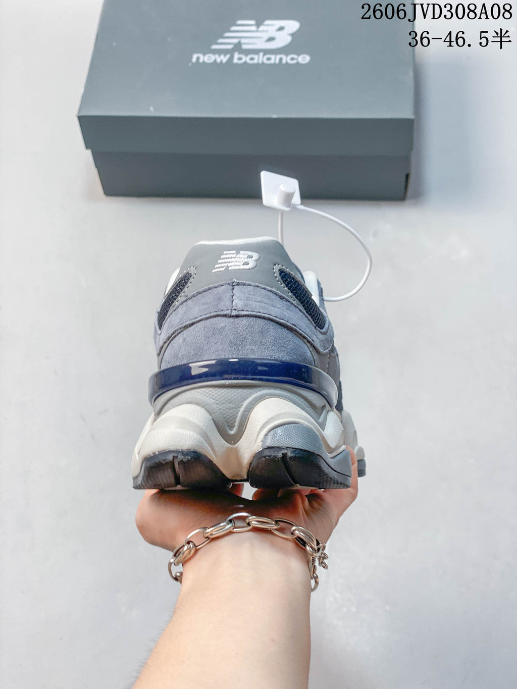Rear view of a blue-grey New Balance 9060 sneaker with a sculpted sole