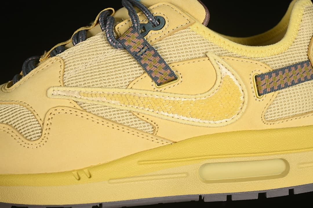 Close-up of the side swoosh, mesh panels, patterned laces, and visible heel air unit.