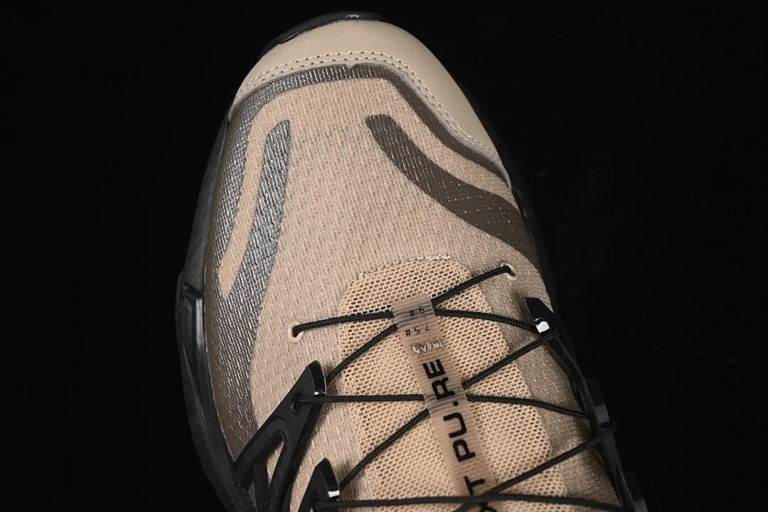 Top detail of the shoe showing XT Pu.re text and quick-lace cords.