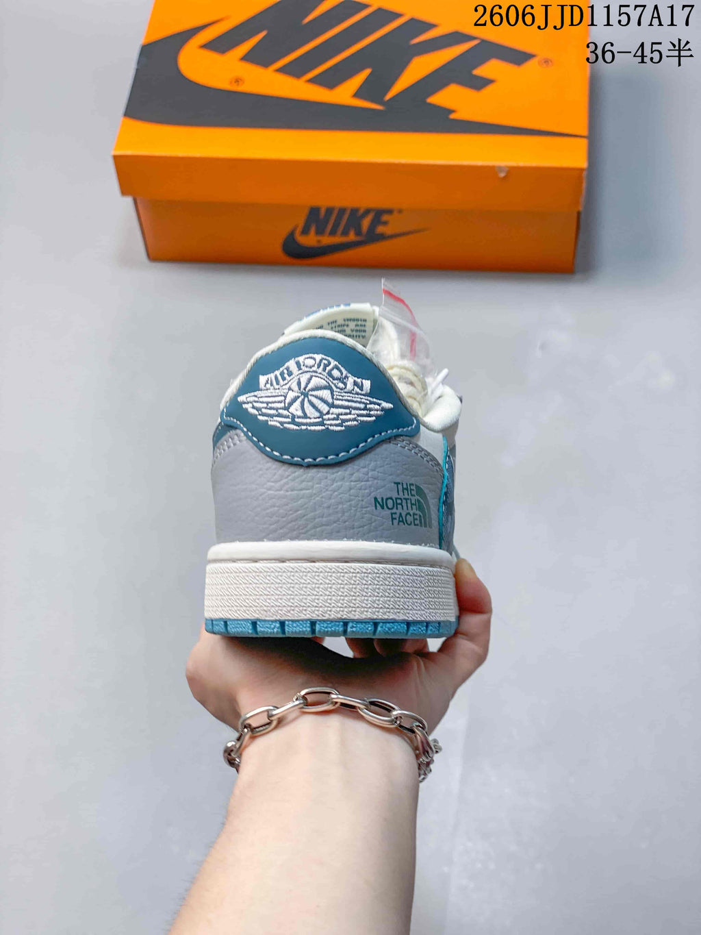 Rear view showing the blue heel tab and grey heel panel.