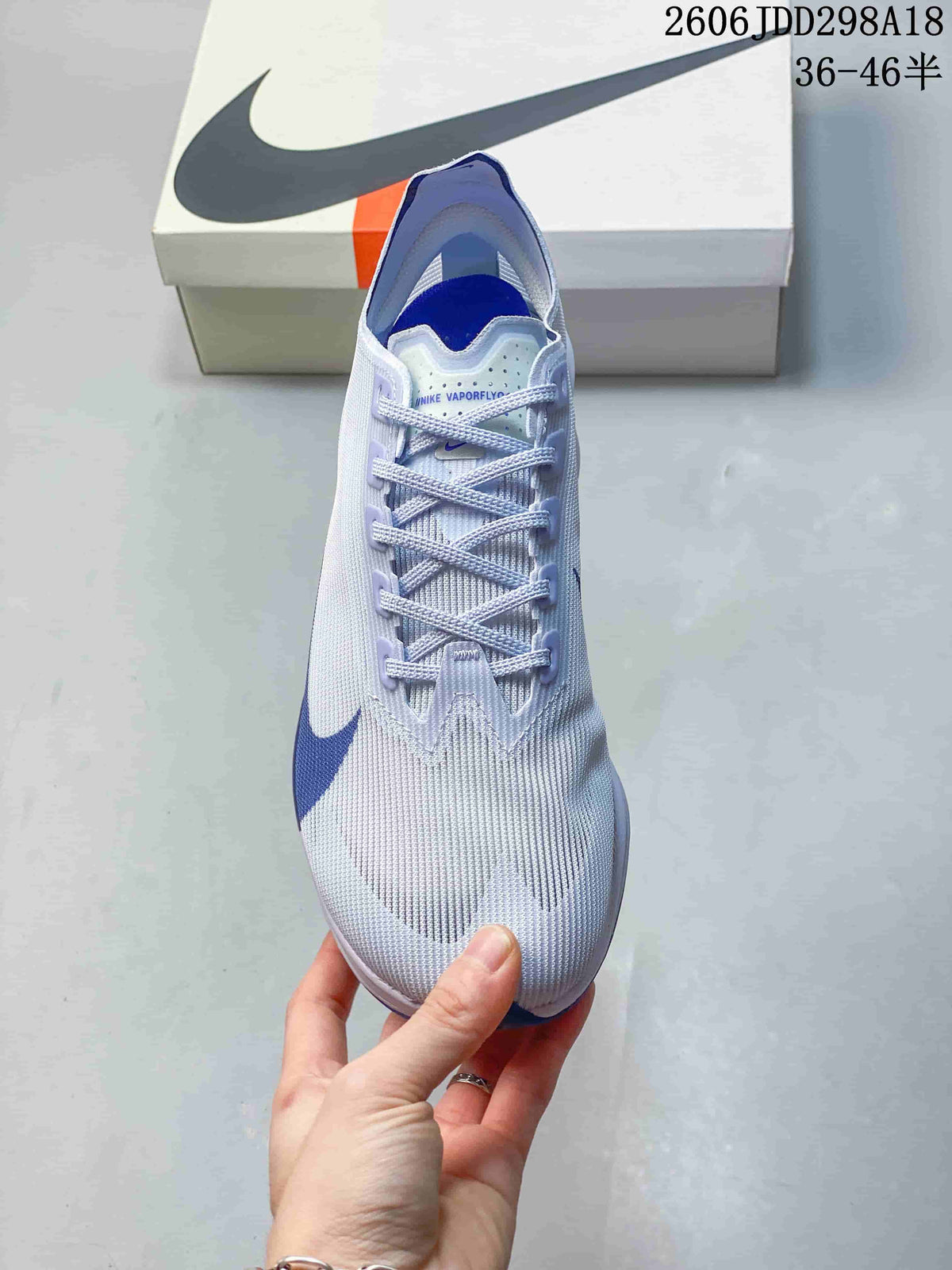 Top view showing the laces, tongue and light-colored upper