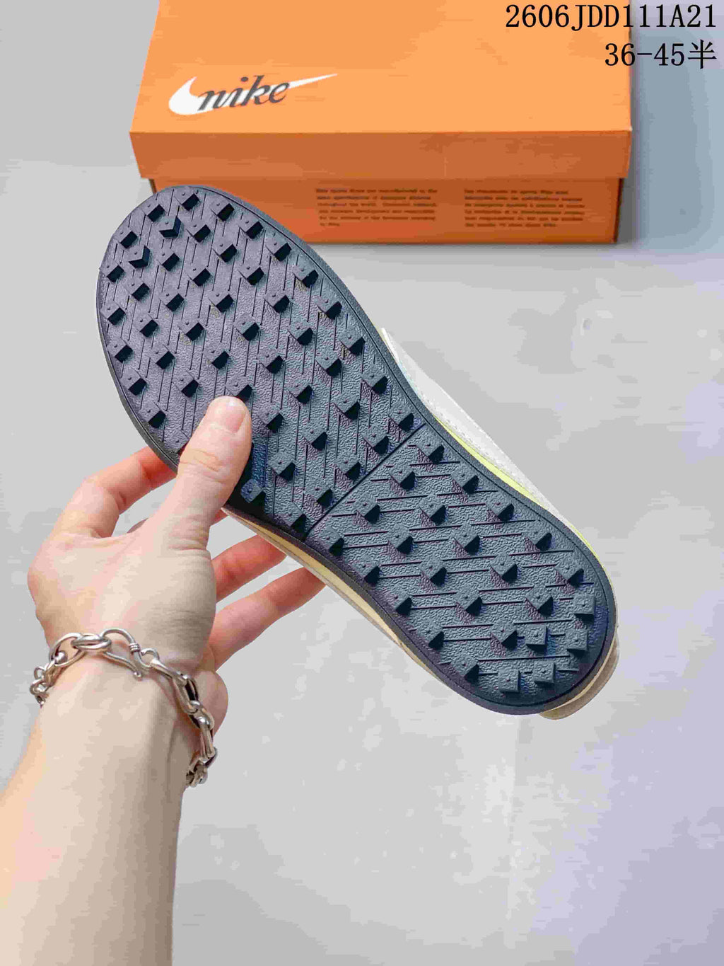 Close-up of the dark patterned outsole on the Nike Moon Shoe OG Summit sneaker.