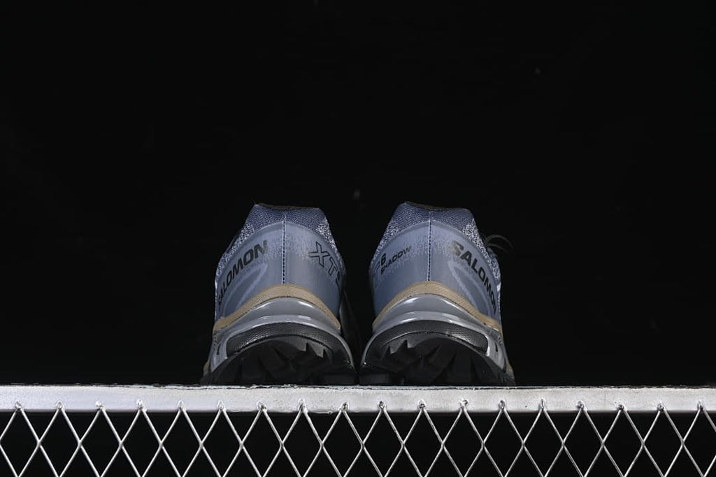 Rear view of the pair showing heel details and outsole lugs