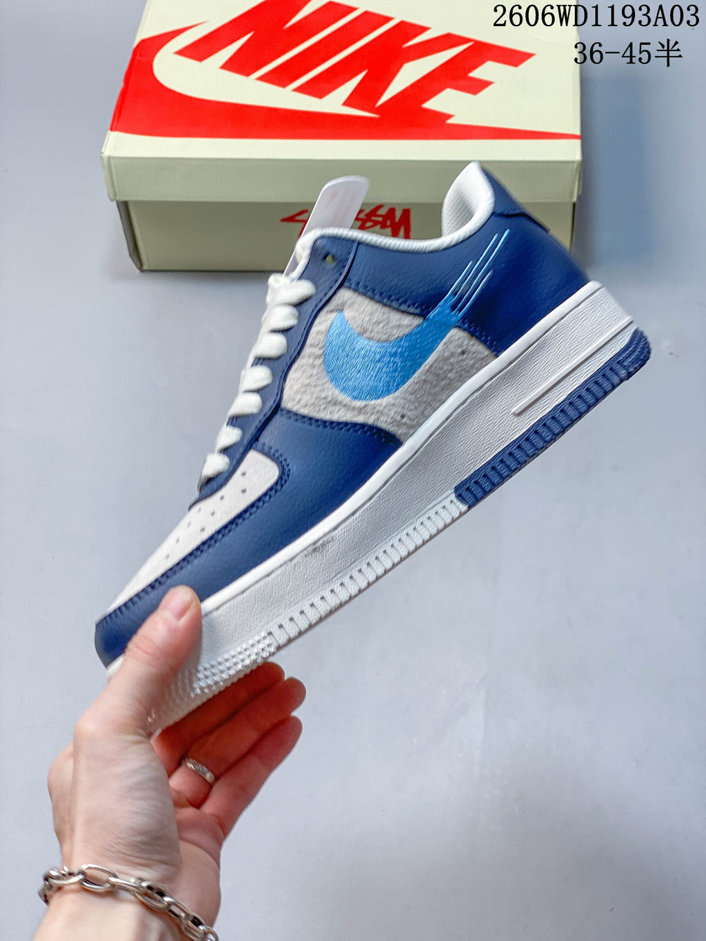 Side view showing blue overlays, gray panels, and a light blue side logo