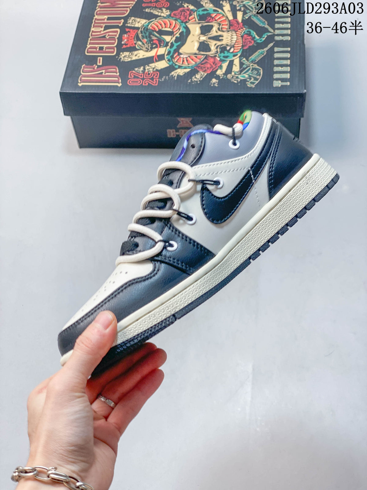 Side profile of the white and navy low-top Jordan sneaker