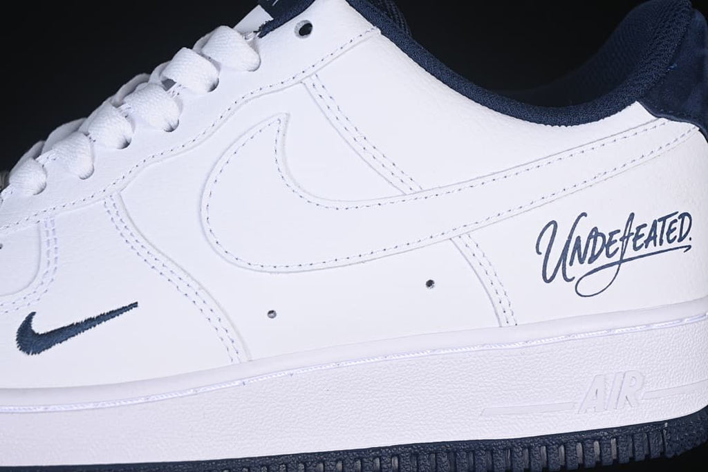 Close-up of the side Swoosh, Undefeated lettering, and white midsole