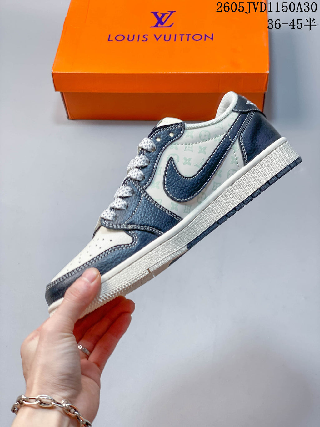Side profile of a low-top sneaker with navy overlays and patterned white panels