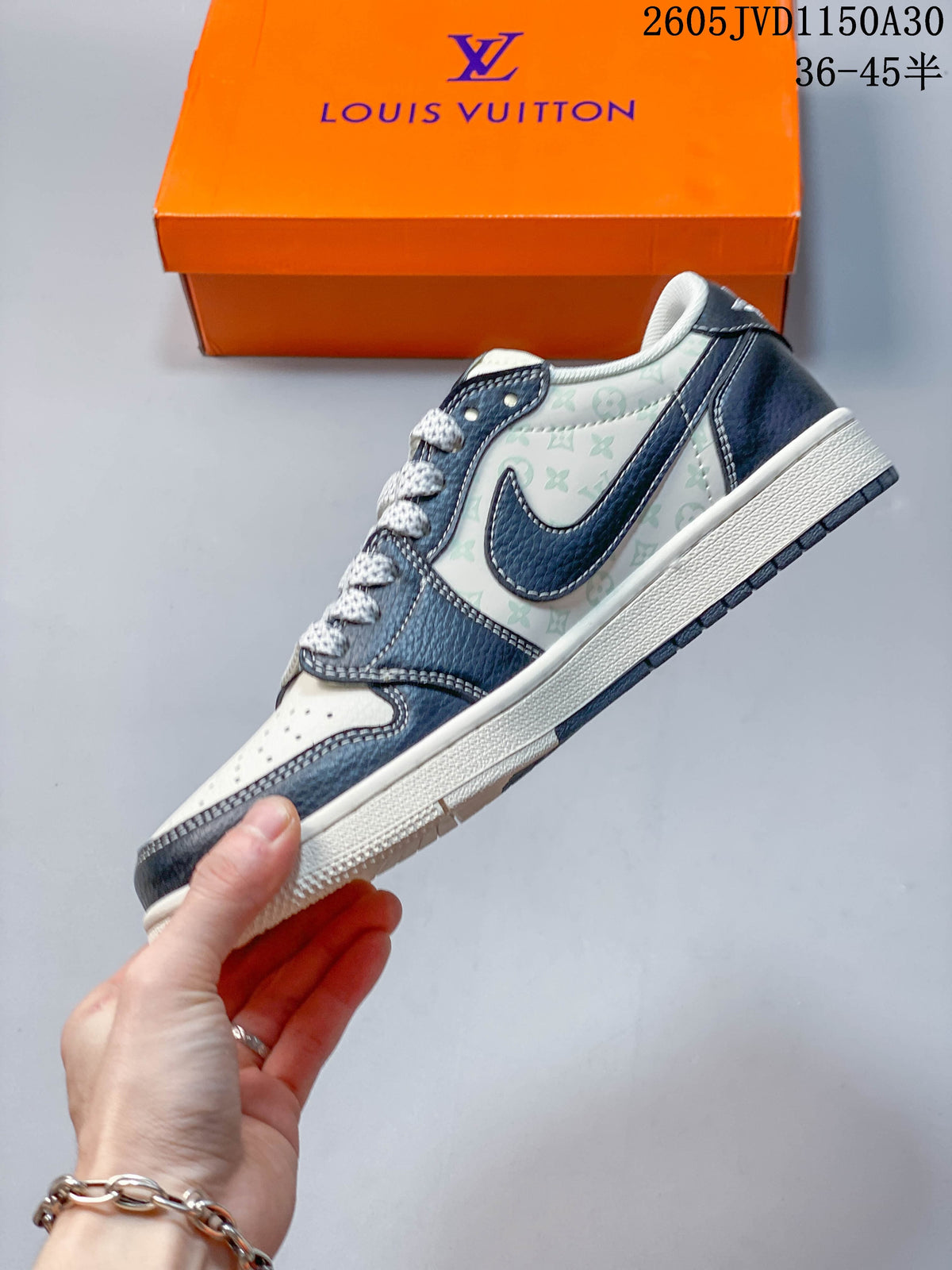 Side profile of a low-top sneaker with navy overlays and patterned white panels