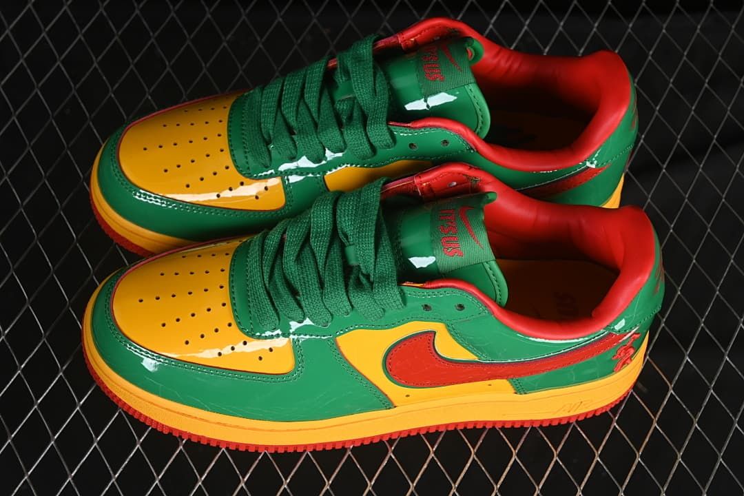 Pair of green, yellow, and red low-top sneakers shown from above and the side