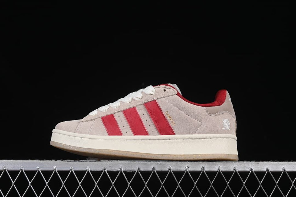 Side view of light neutral Adidas Campus 00s sneakers with red stripes and cream sole