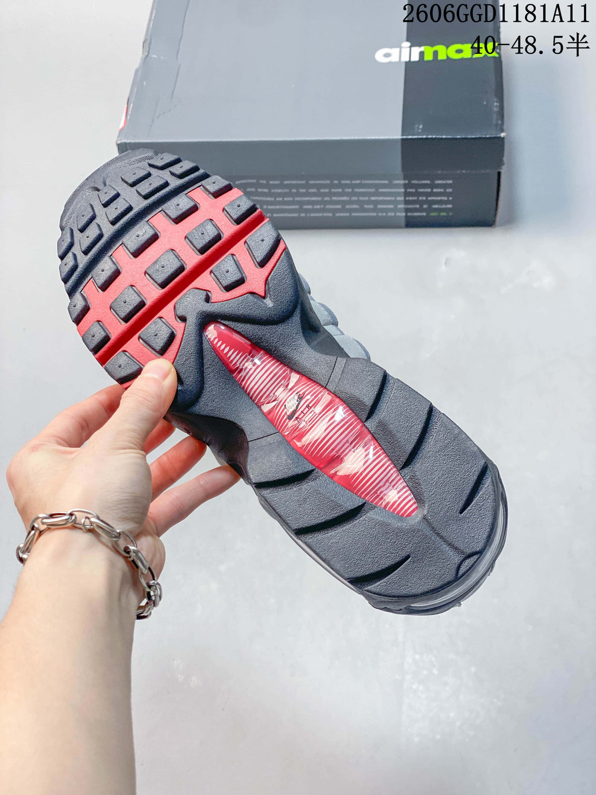 Close-up of the outsole with red tread details and a visible cushioning unit