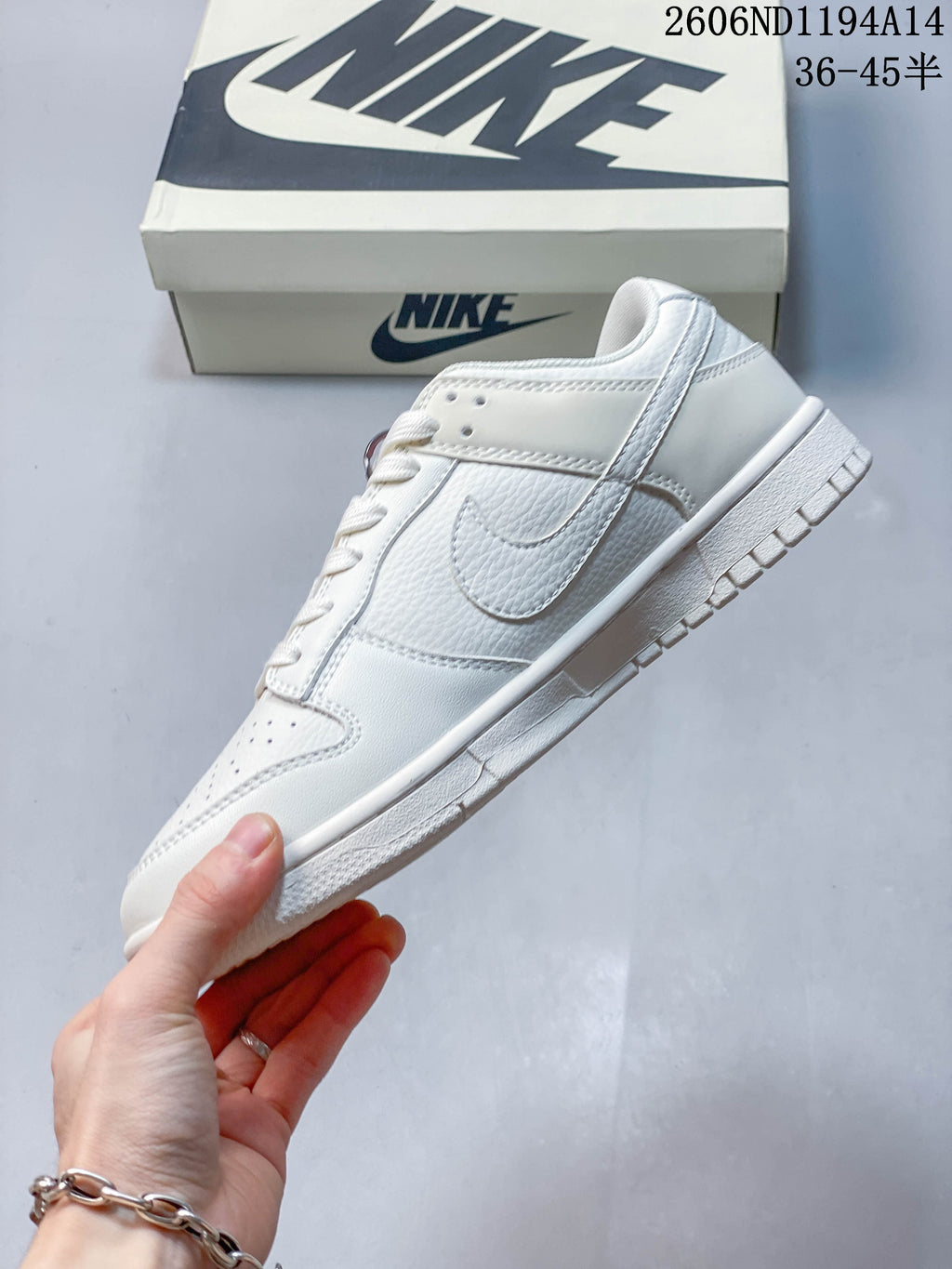 Side profile of the white low-top sneaker with a tonal Swoosh