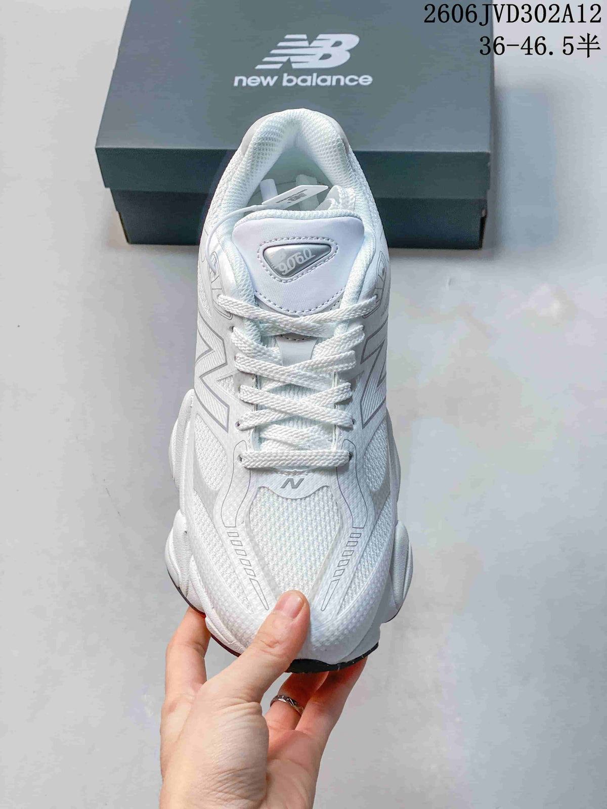 Front view of the sneaker showing the laces, mesh-textured toe, and 9060 tongue badge.