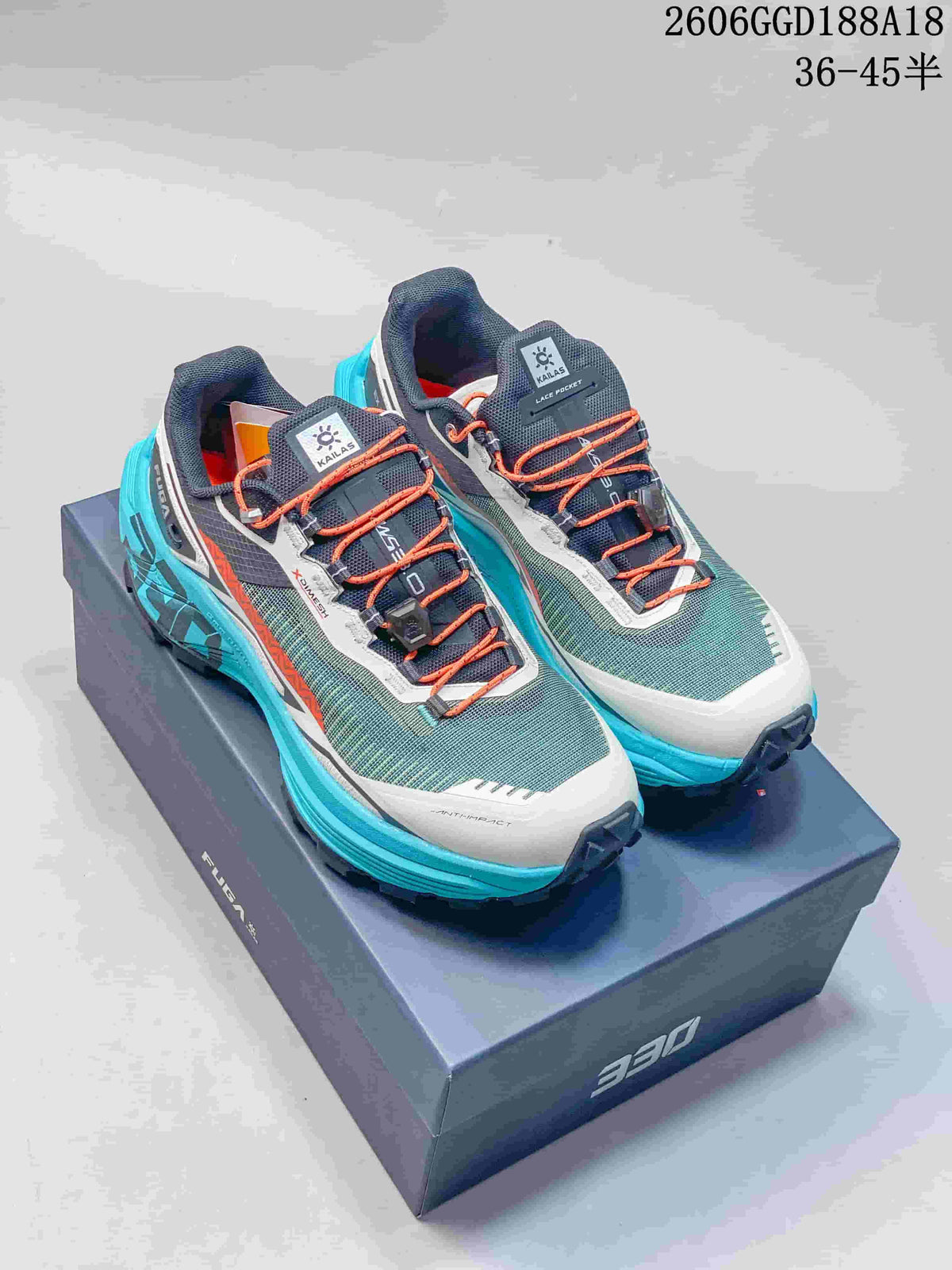 Pair of teal, gray, white, and orange Kailas FUGA trail shoes on a box
