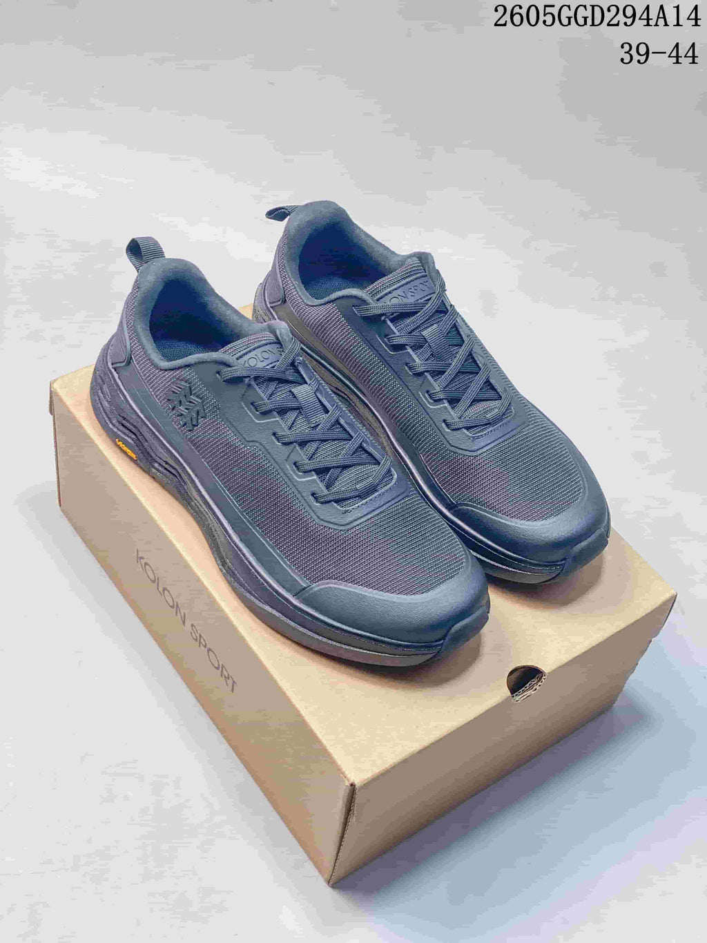 Pair of charcoal Kolon Sport low-top sneakers displayed on a branded box