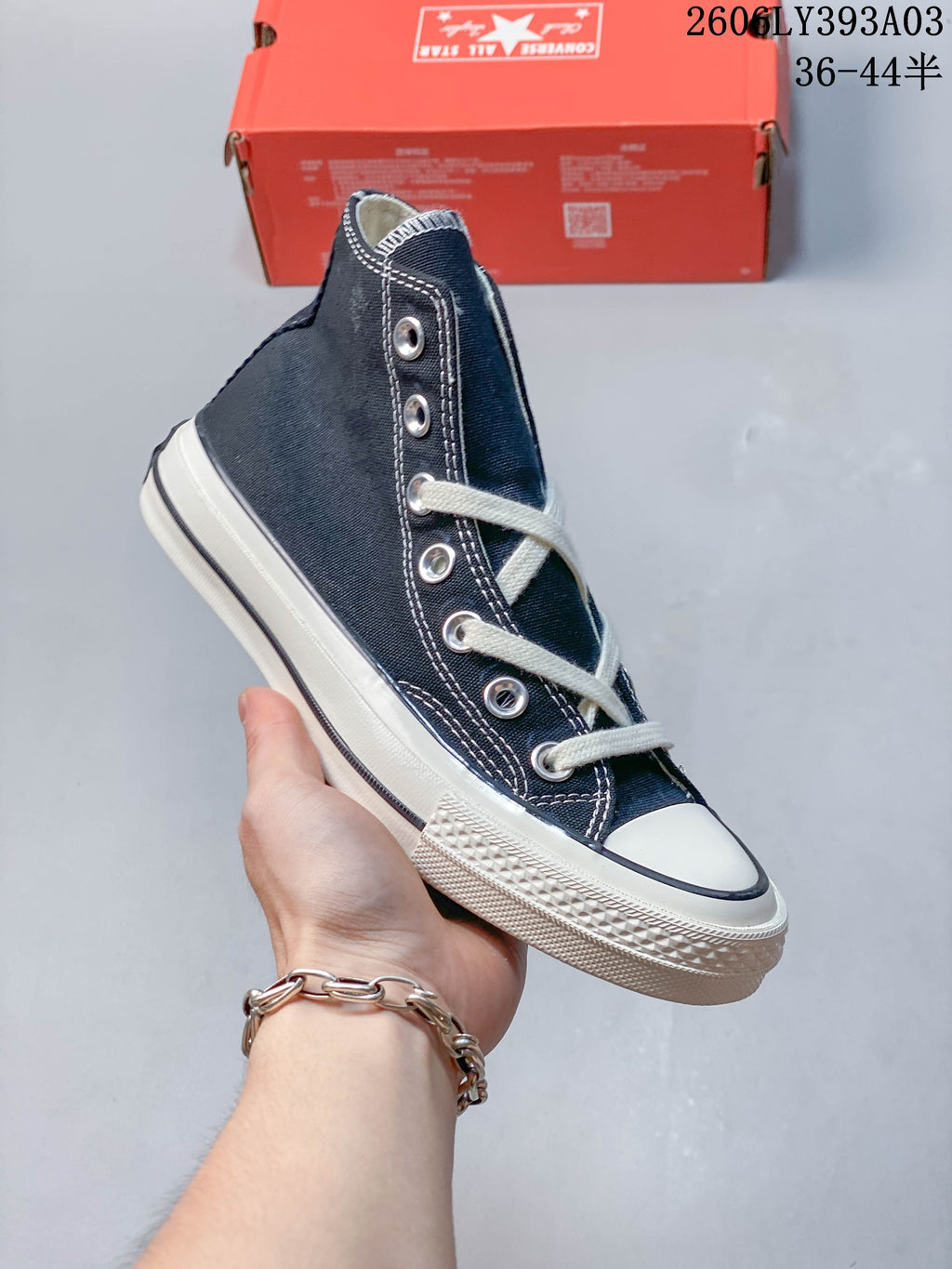 Navy high-top sneaker with white contrast stitching and laces
