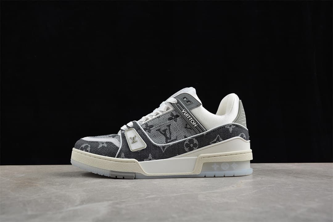 Side profile of a gray patterned sneaker against a dark background.