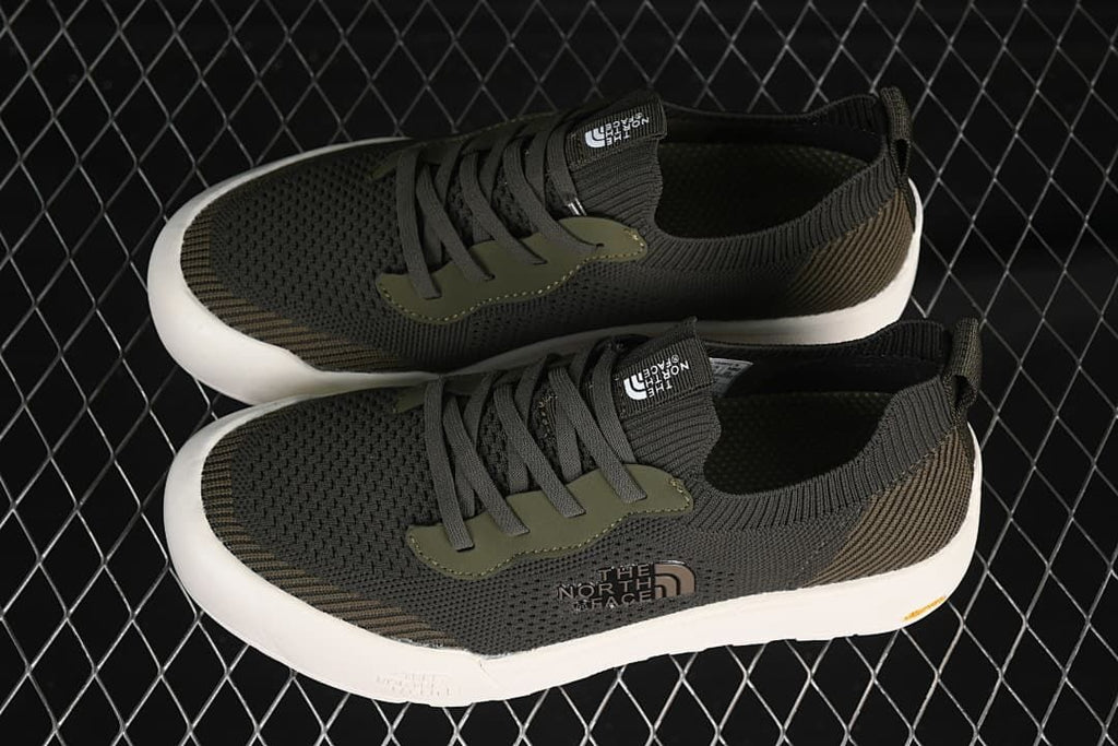 Pair of army green low-top sneakers shown from above
