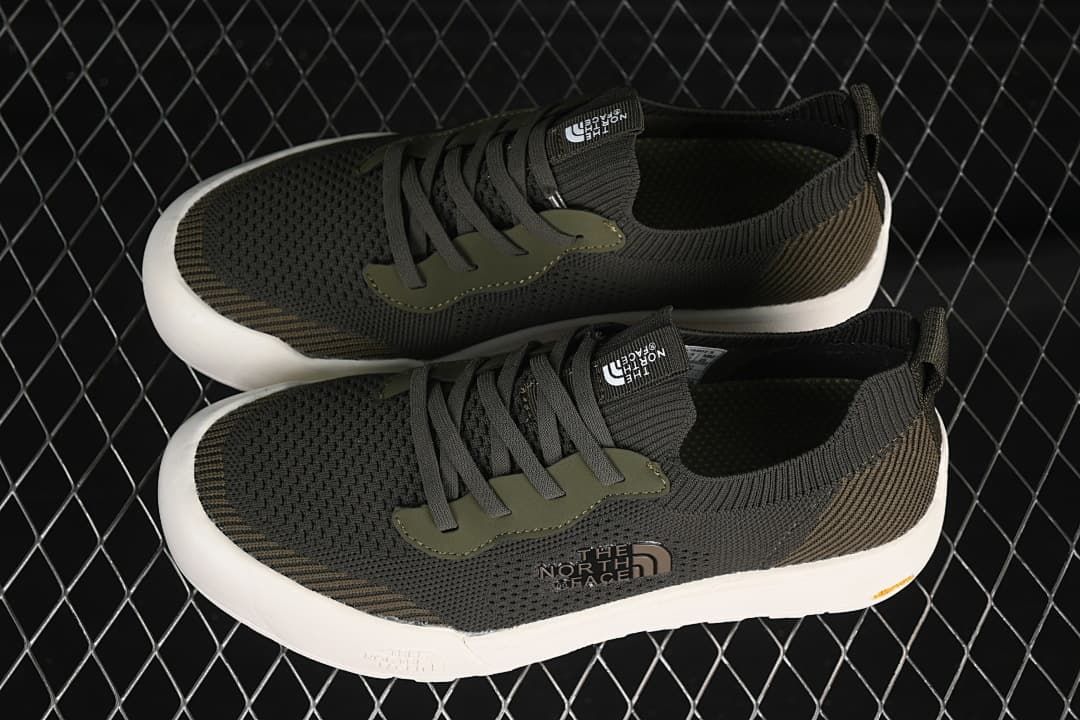 Pair of army green low-top sneakers shown from above