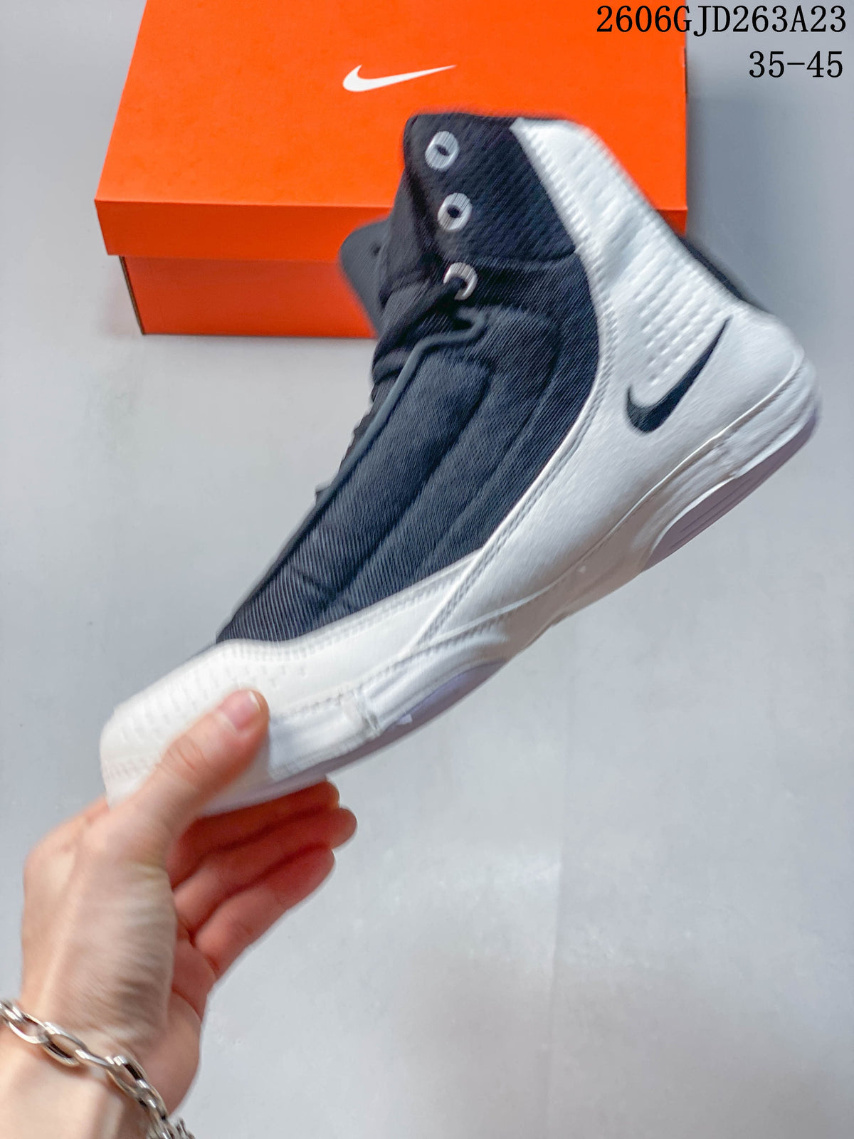 Side profile of the navy and white Nike wrestling shoe