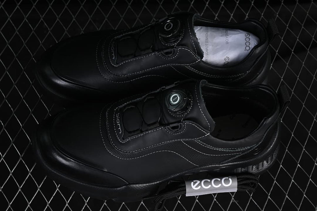 Pair of black ECCO BIOM sneakers with dial closures