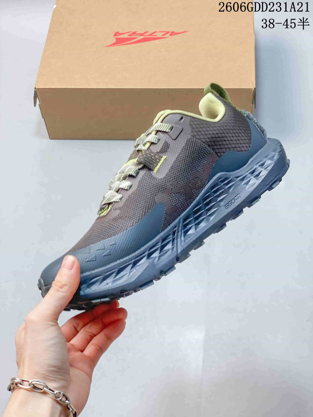 Side view of the trail shoe with its lugged outsole and layered upper