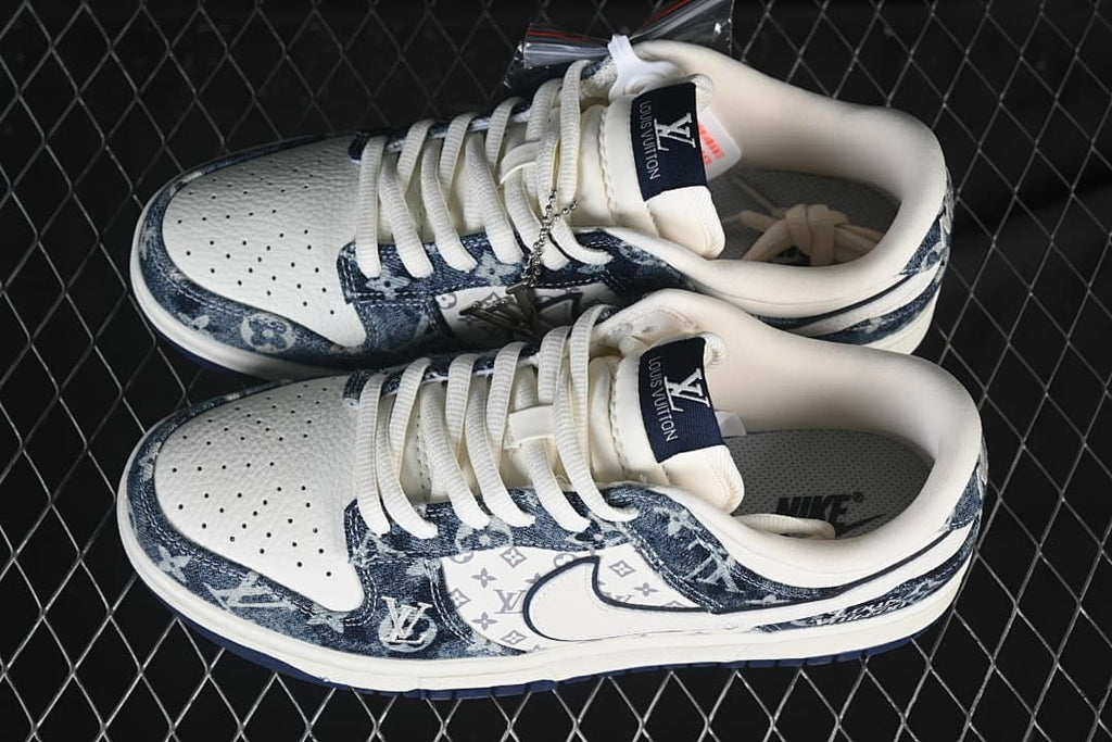 Top view of white and blue Nike SB Dunk Low sneakers showing the perforated toe boxes and laces