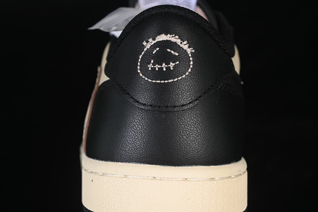 Close-up of the black heel with embroidered graphic detail