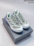 Pair of pale gray and white Kailas C4 low-cut trail shoes with lavender accents, shown on a box
