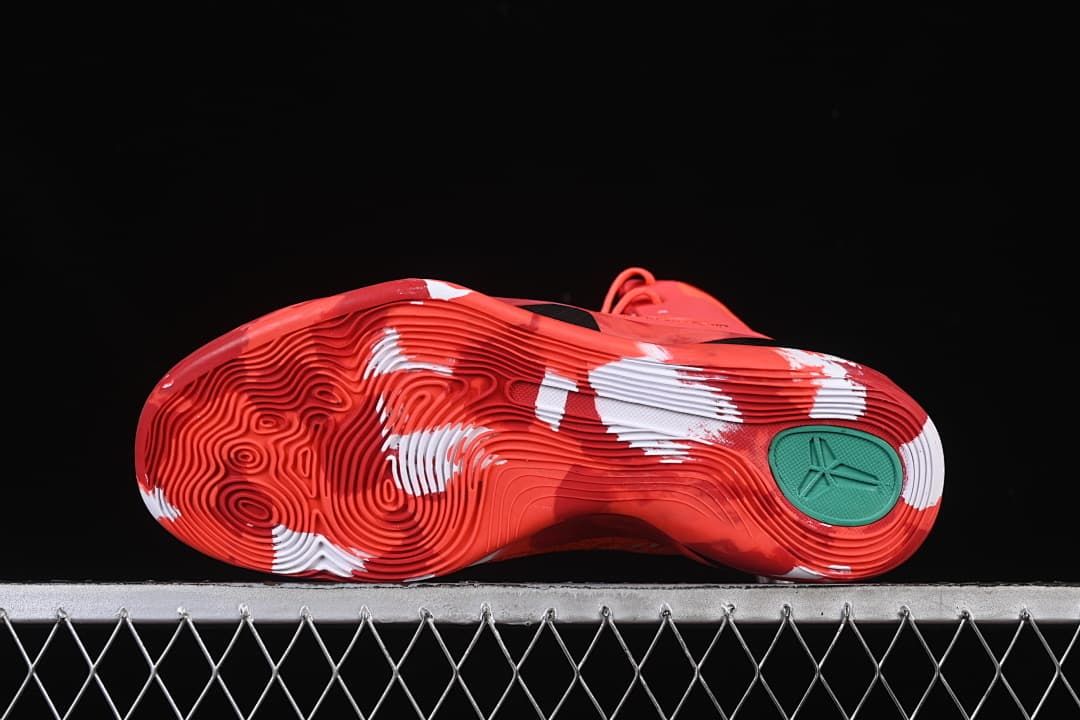 Underside view showing the red-and-white patterned outsole and teal insert