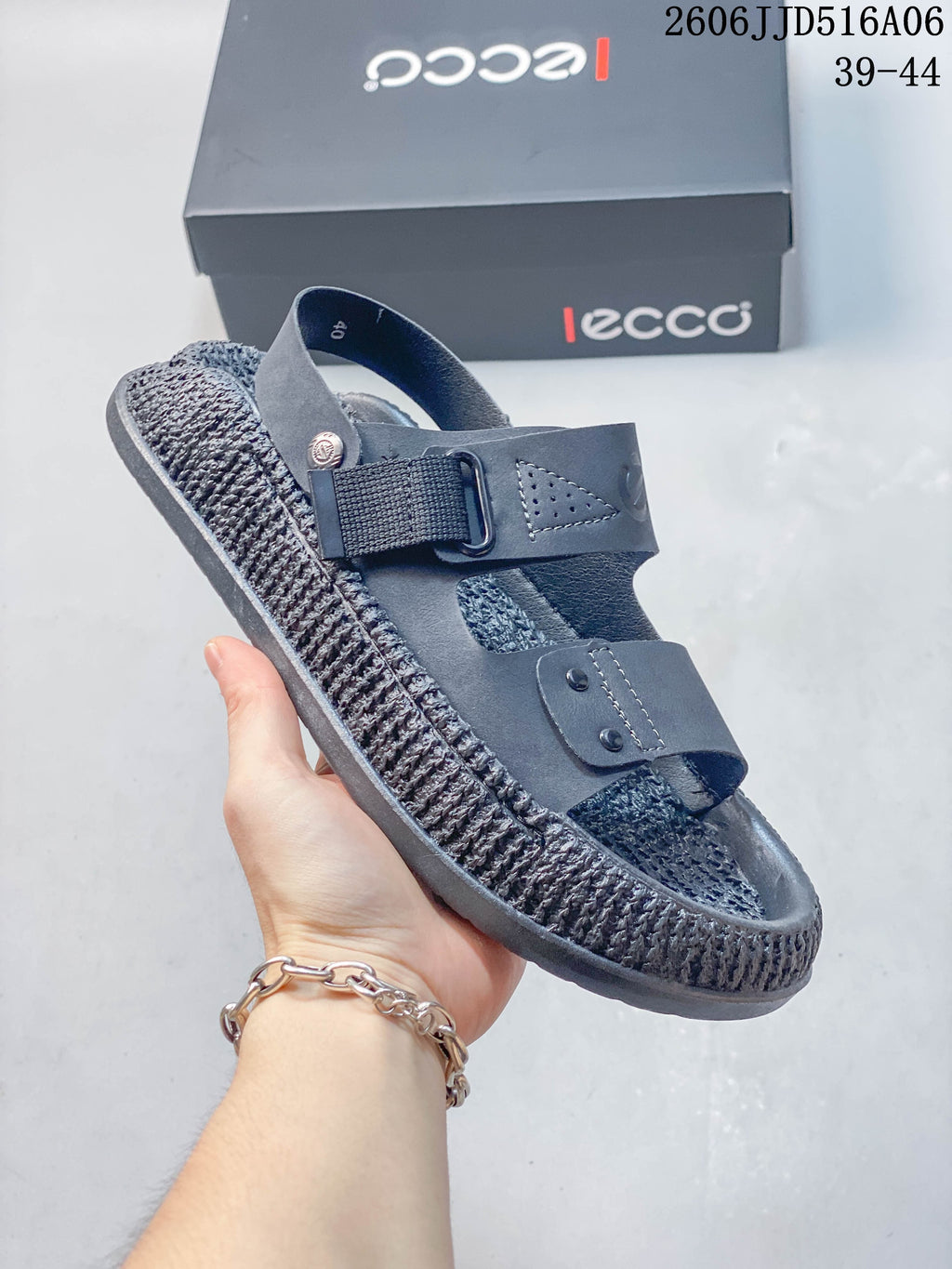 Angled view of the gray sandal showing its adjustable strap, heel strap and textured sole; the image shows size range 39–44.
