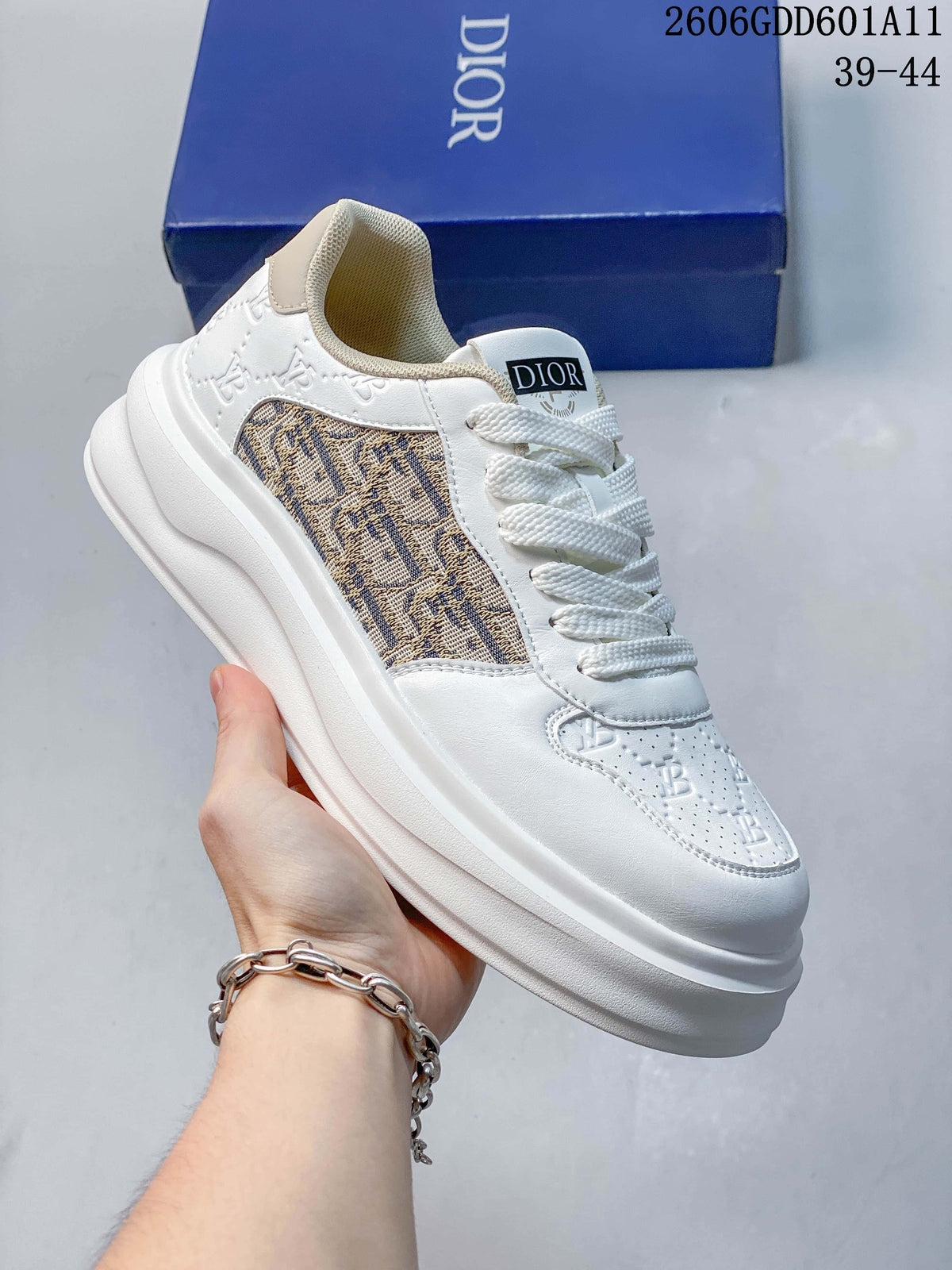 Angled view of the white sneaker with beige patterned side panel and thick sole.