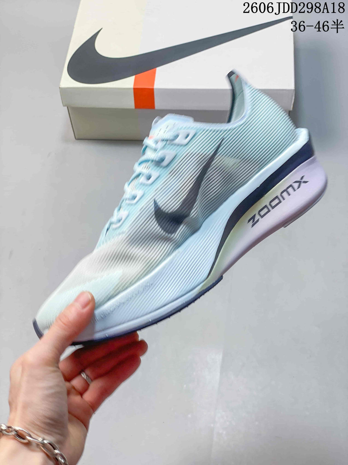 Side view of a pale blue Nike ZoomX Vaporfly NEXT% 4 shoe