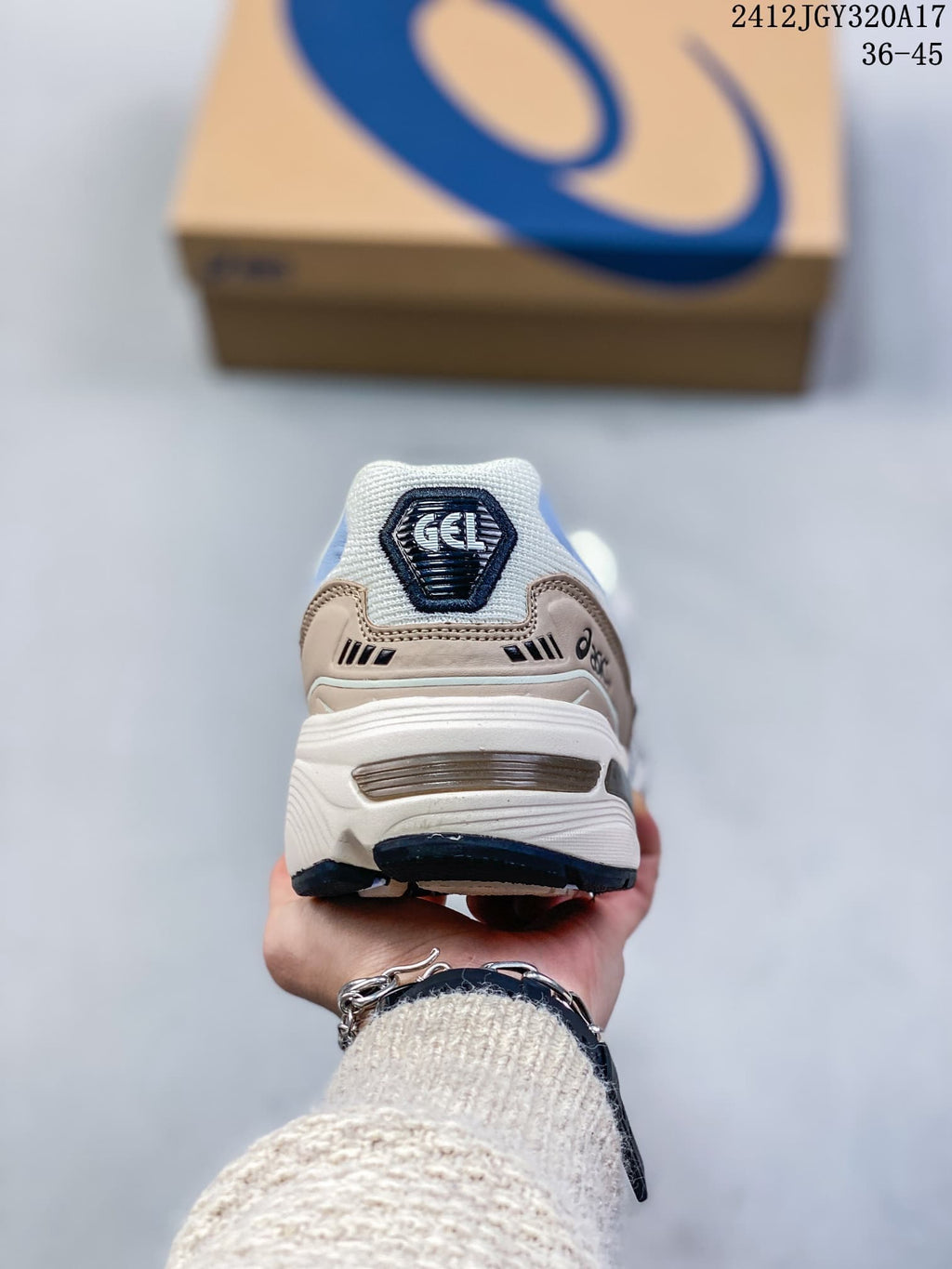 Rear view of a white and blue ASICS GEL-1090 sneaker showing the heel and sculpted sole; image shows size range 36–45.