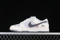 Side view of off-white and grey Nike Dunk Low sneakers with dark grey Swoosh and red accent