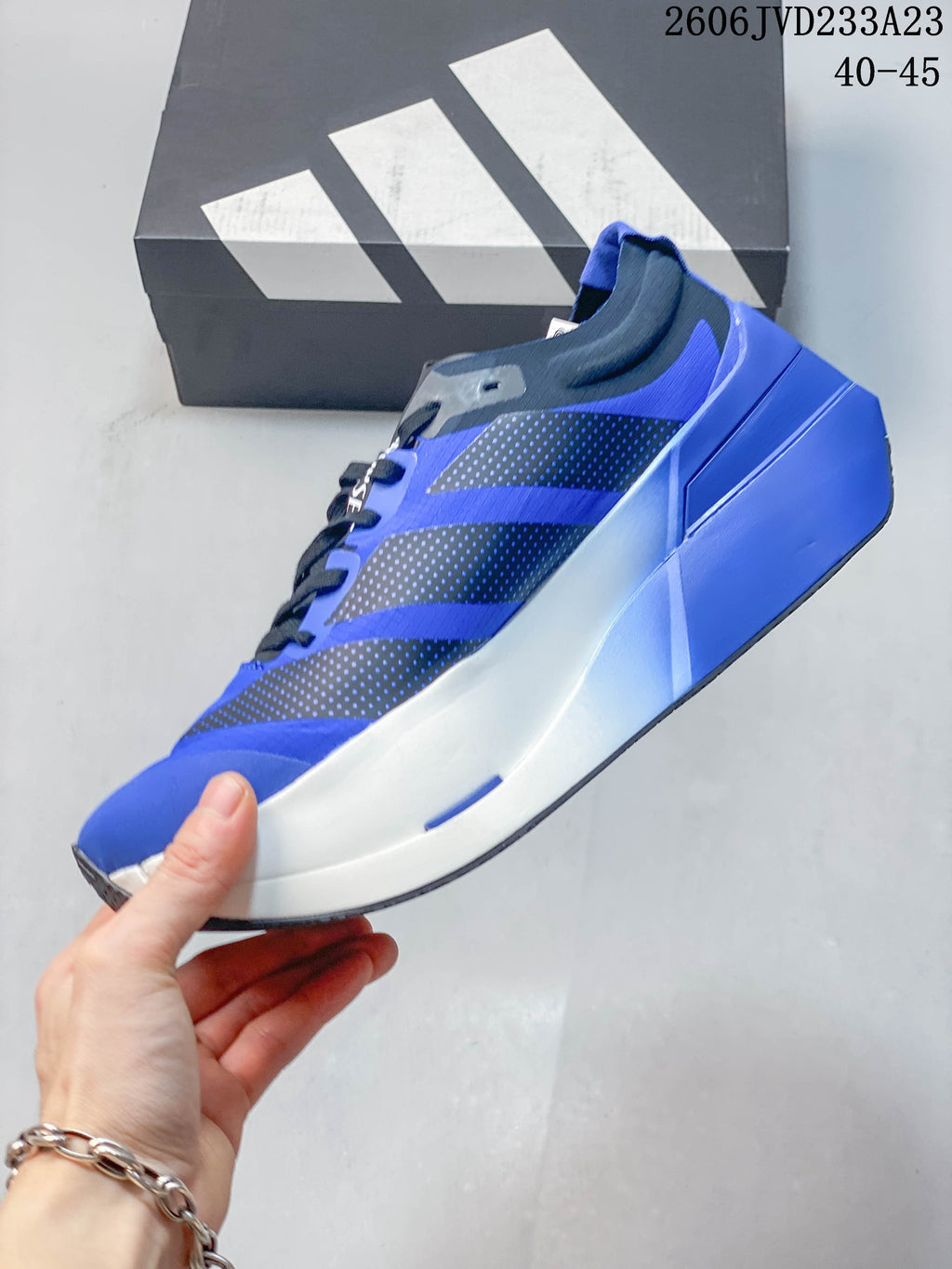 Side view of the blue running shoe with dark patterned overlays and sculpted midsole