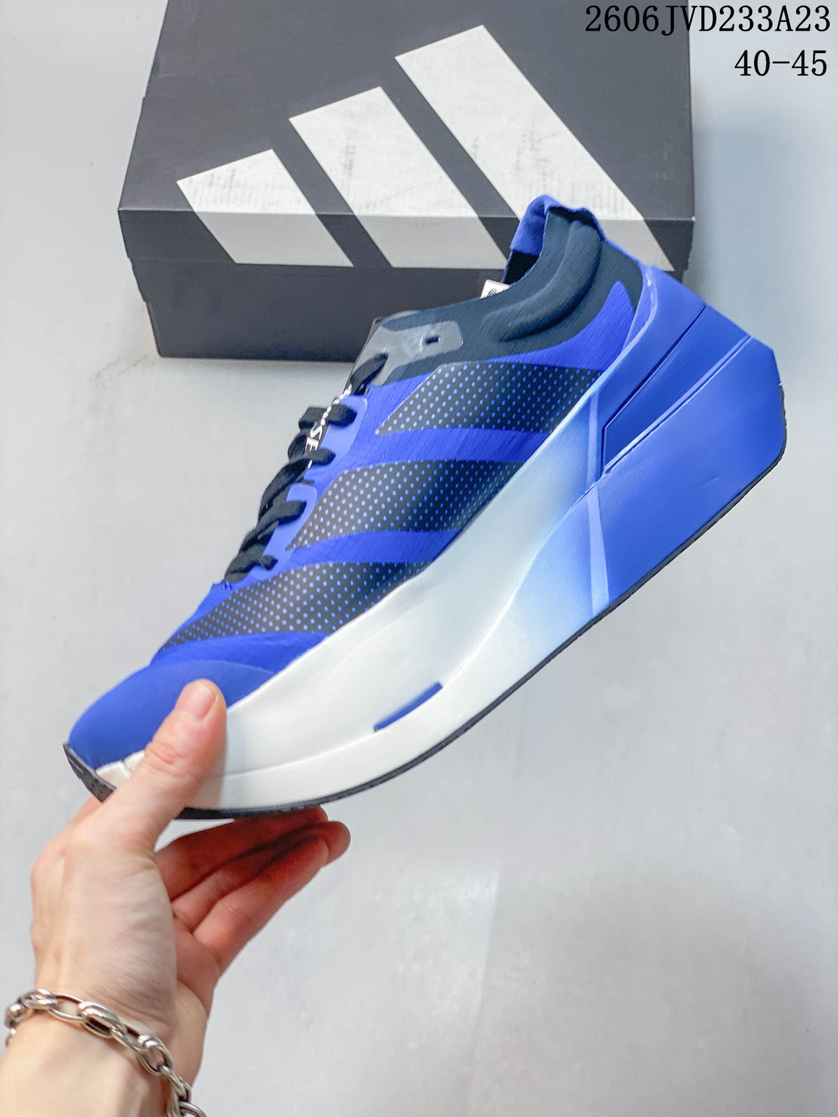 Side view of the blue running shoe with dark patterned overlays and sculpted midsole