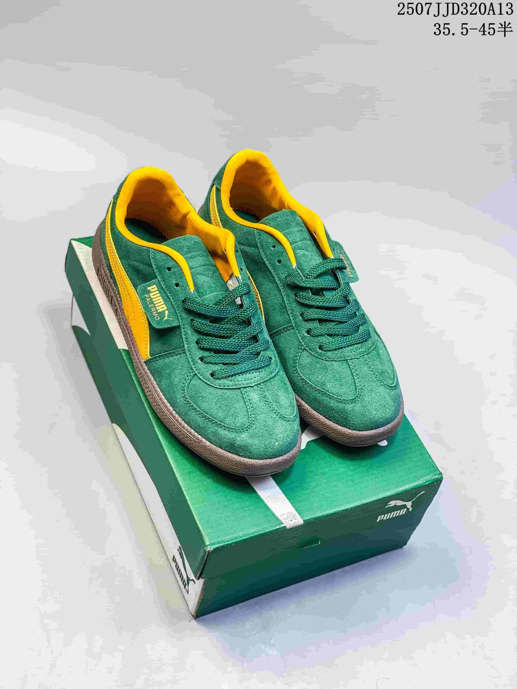 Pair of green and yellow PUMA Palermo Leather sneakers on a green shoe box.