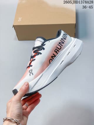 Side view highlighting the sculpted white sole and graphic lettering on the On Cloudboom Volt.