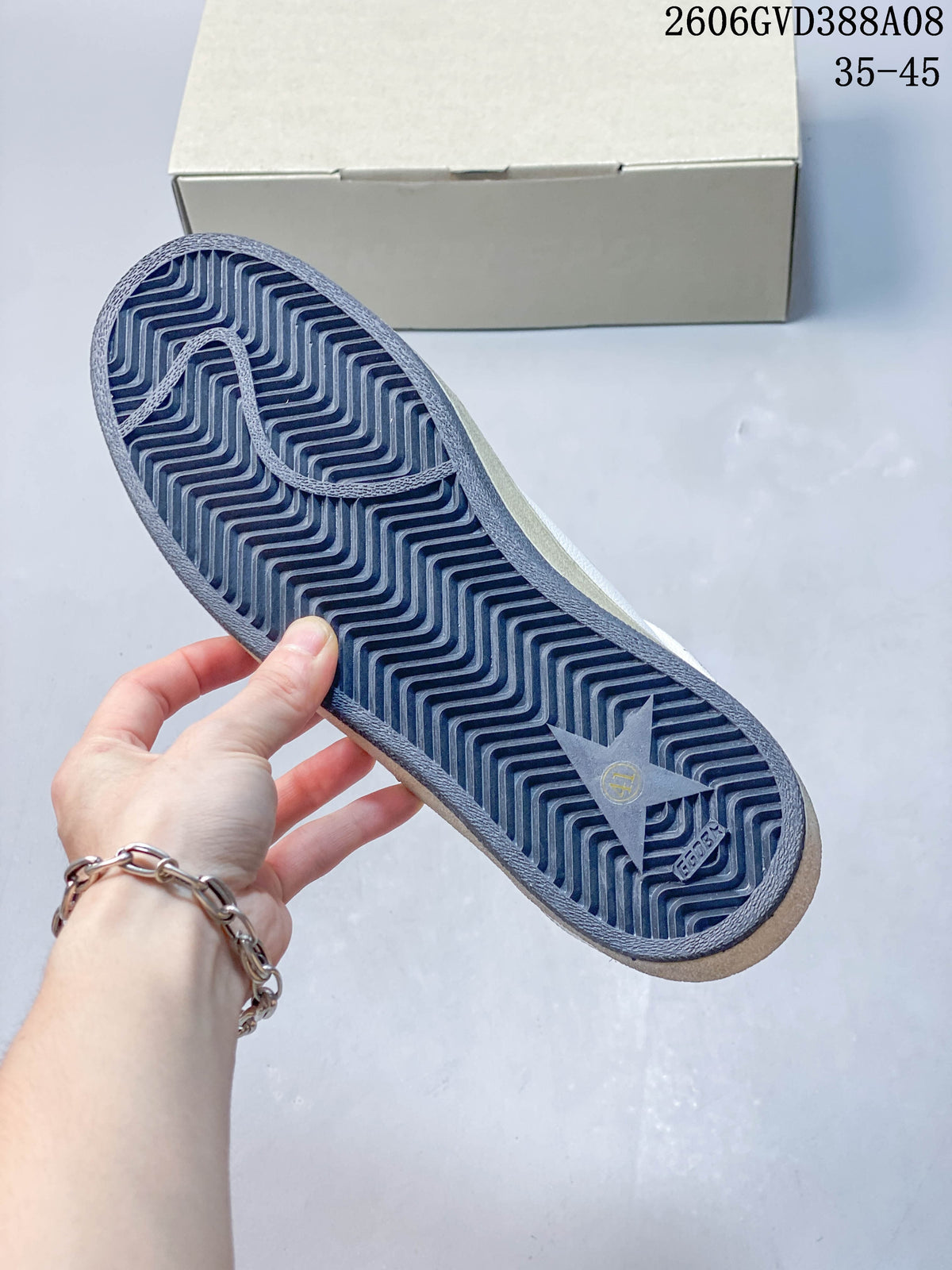 Underside of the sneaker showing a navy patterned outsole