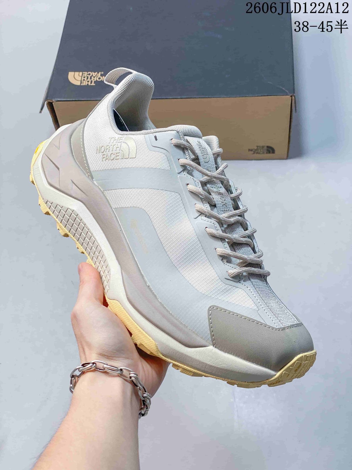 Side view of a gray The North Face Fastpack hiking shoe with a contrasting pale yellow outsole.