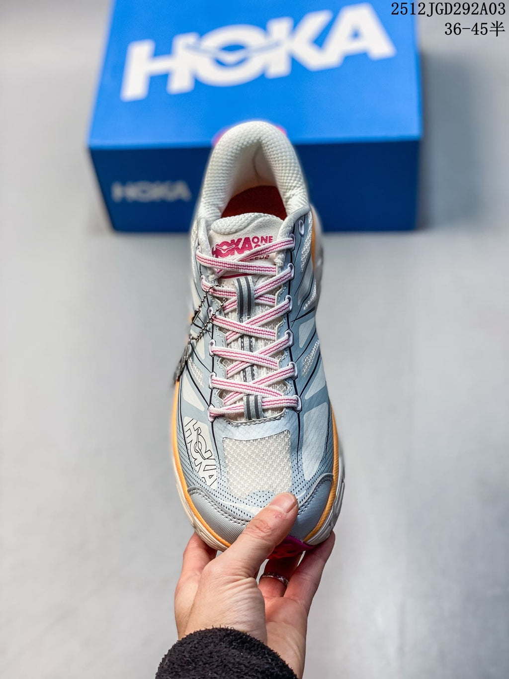 Front view of a HOKA Mafate Speed 2 shoe with pink laces and light blue upper.