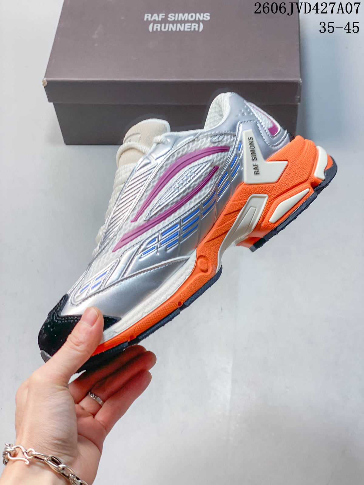 Side view of a silver and white sneaker with magenta accents, dark toe panel, and orange sole; image overlay shows 35–45.